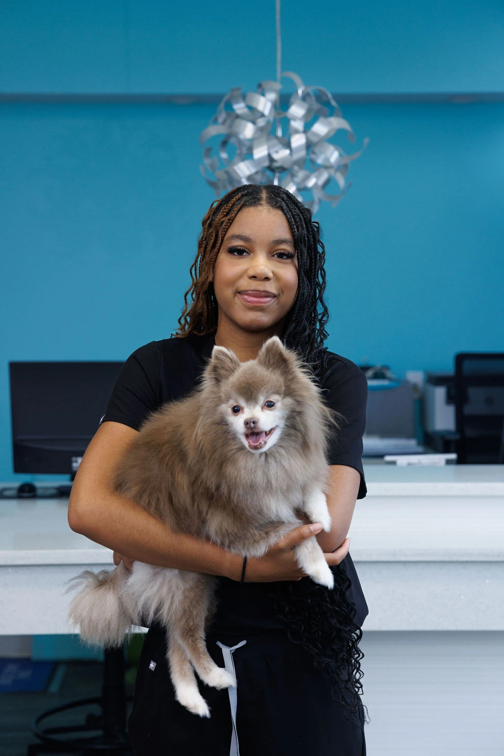 Daija holding a fluffy Pomeranian