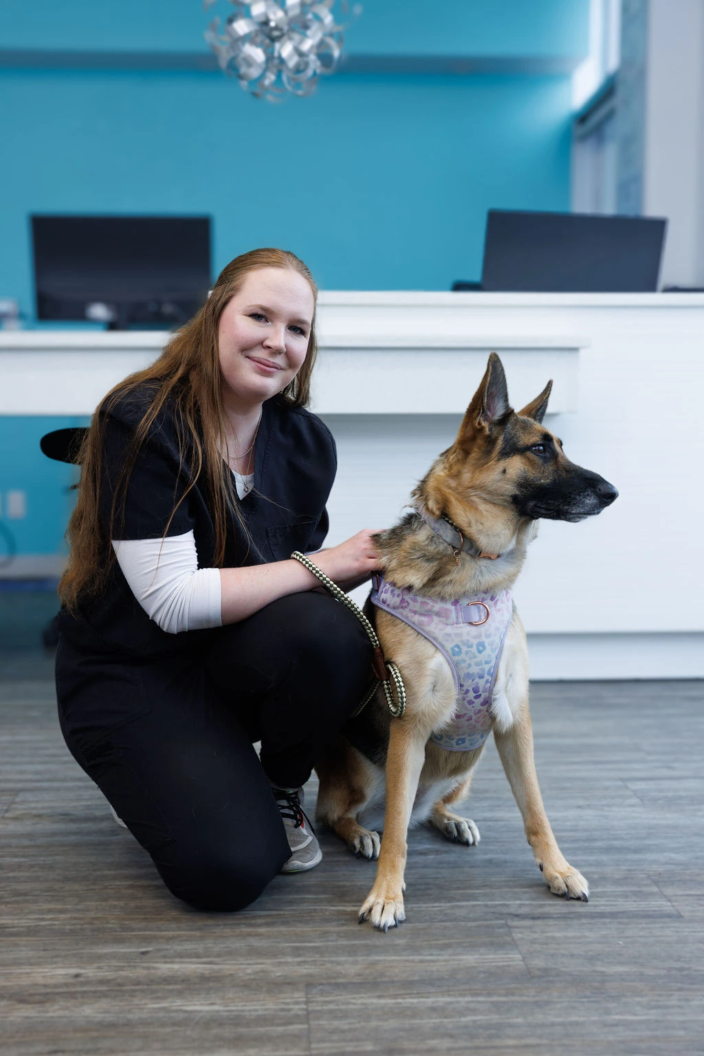 Keeley with a German shepherd looking off to the side