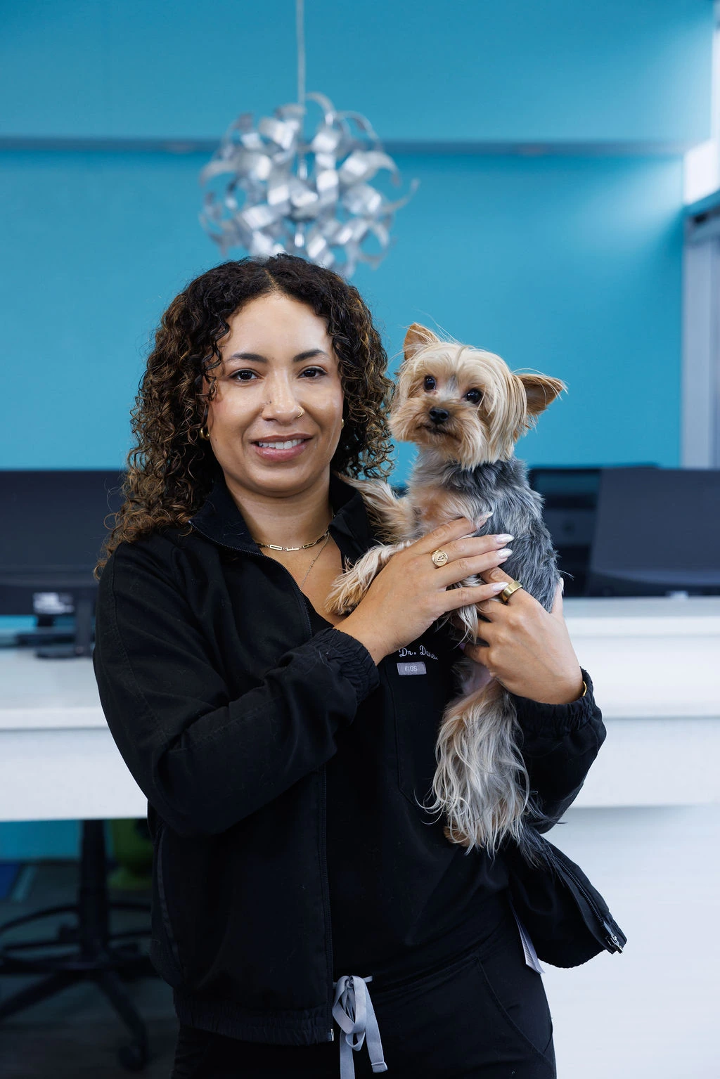 Dr. Rowe holding a Yorkshire terrier in the clinic reception